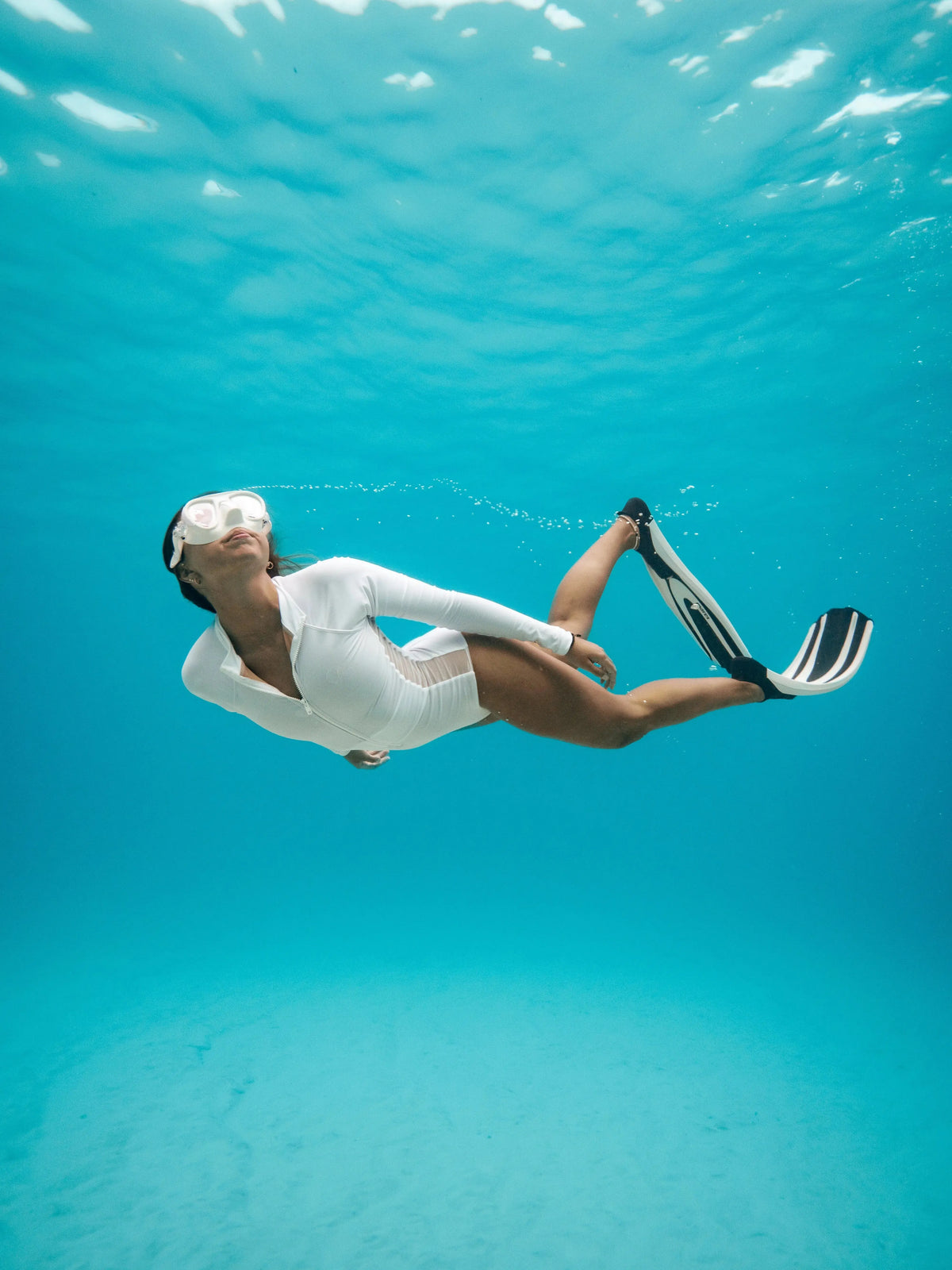 side view of white Long Sleeve Swimwear | The Sulawesi in Snow