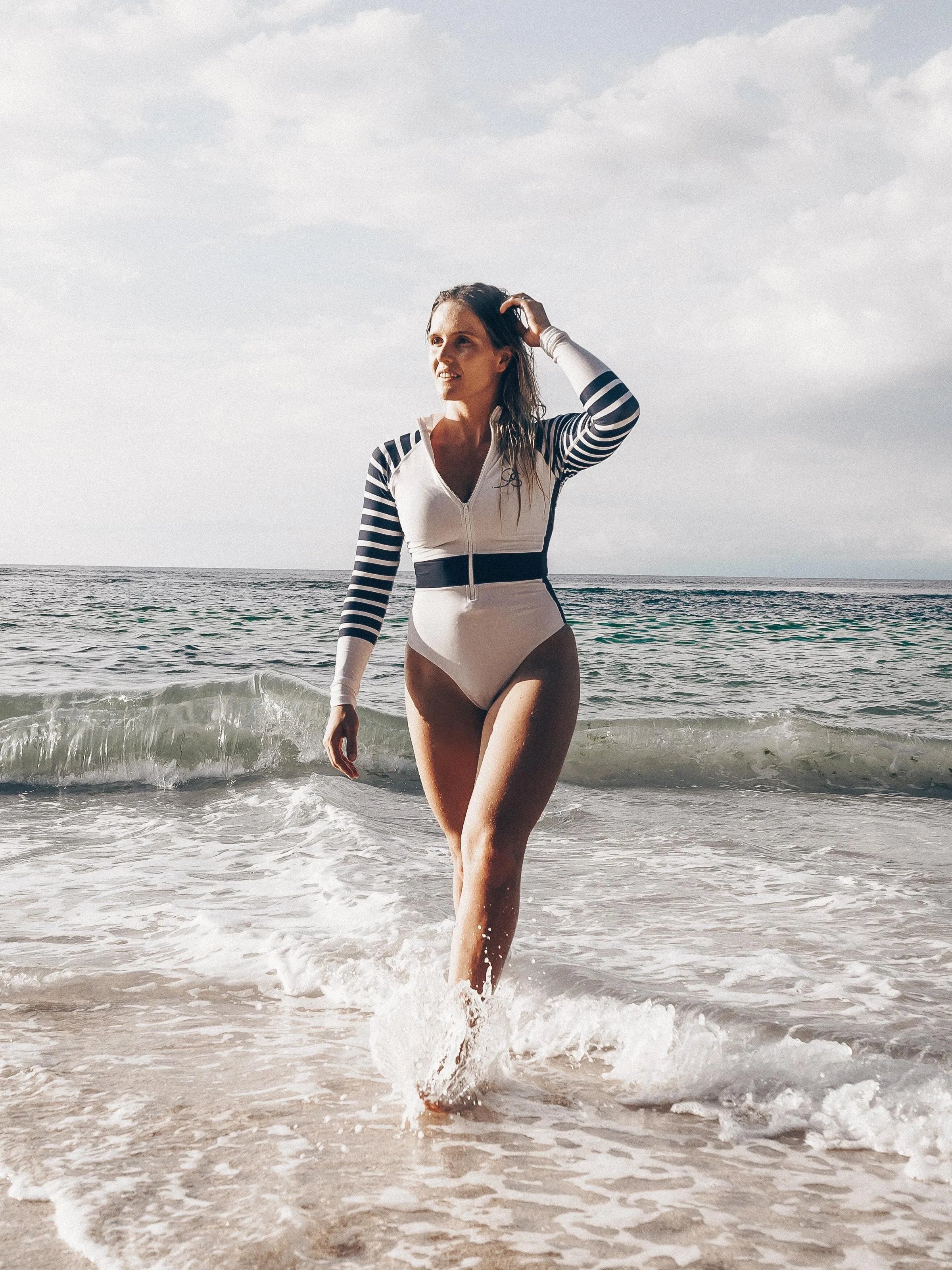 lady at beach Long Sleeve Swimsuit front view | The Sulawesi Snow and Navy-Ocean Soul Swimwear