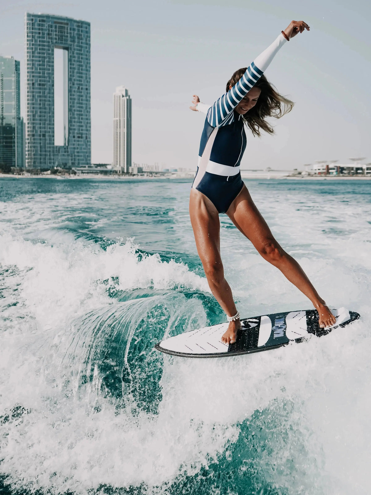 Long Sleeve swimsuit women | The Sulawesi in Nautical - women wake surfing front view