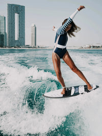 Long Sleeve swimsuit women | The Sulawesi in Nautical - women wake surfing front view