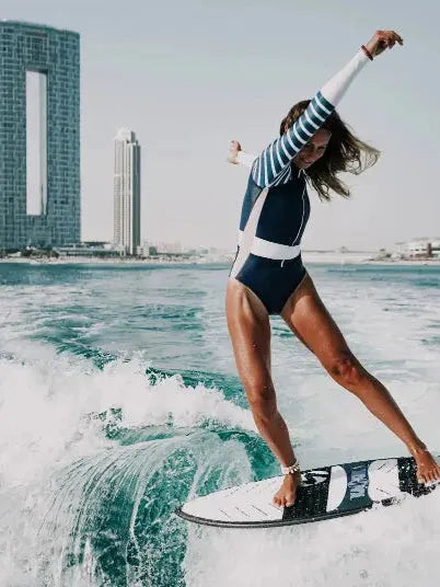 Long Sleeve swimsuit women | The Sulawesi in Nautical - women wake surfing front view
