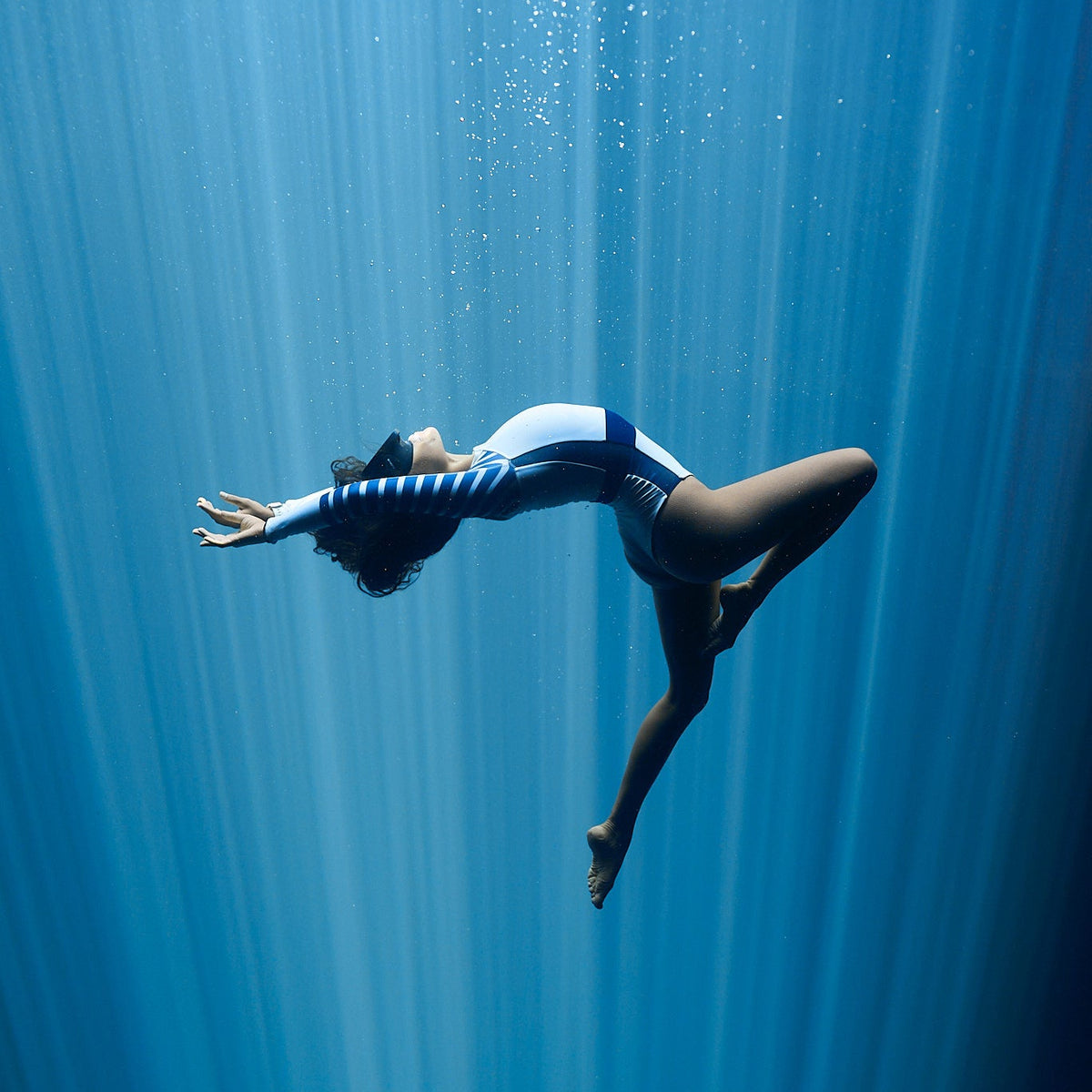 freediver wearing long sleeve swimsuit in white and navy the sulawesi 
