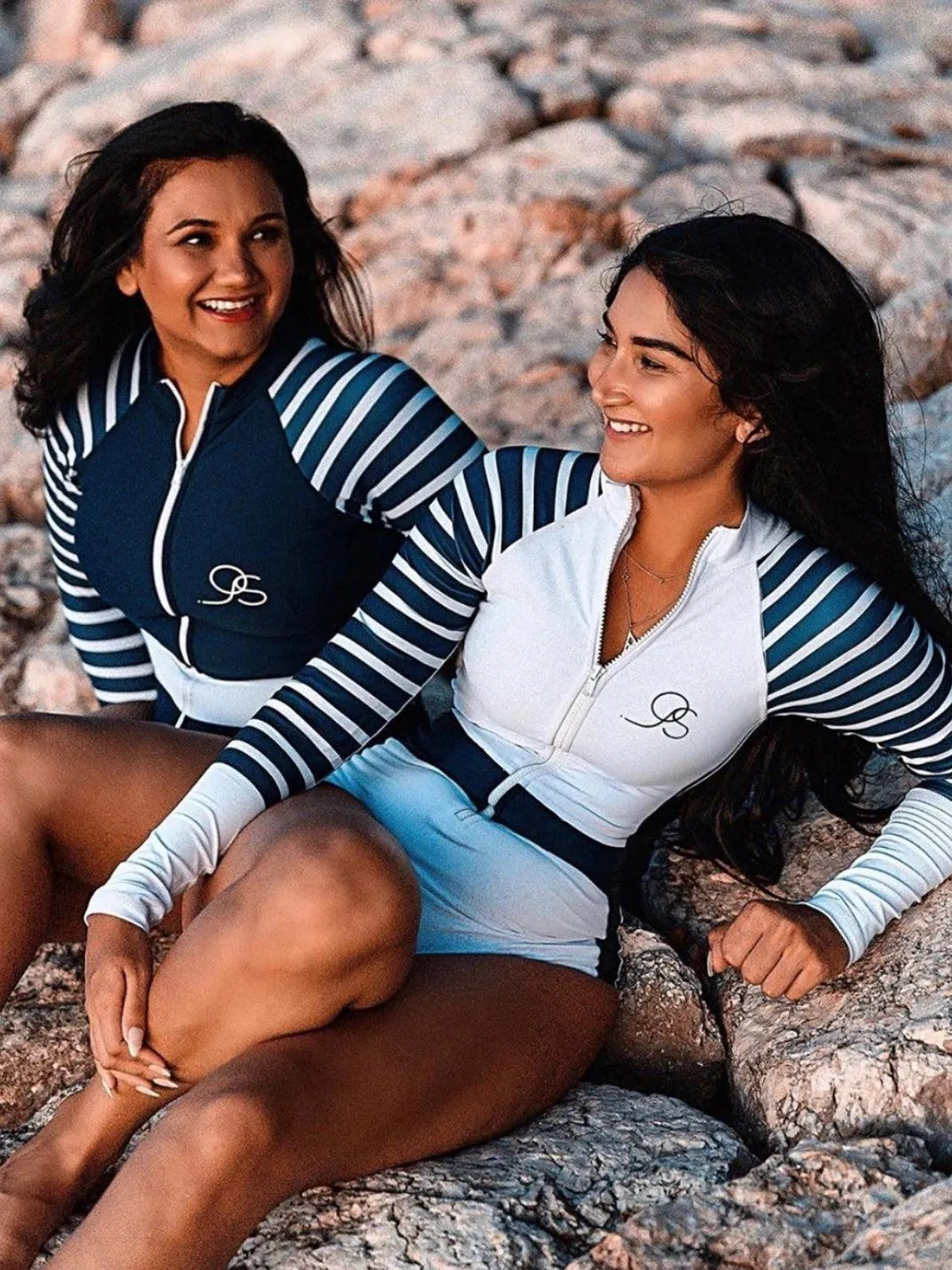 model wearing white Long Sleeve One Piece Swimsuit | The Sulawesi Snow and Navy